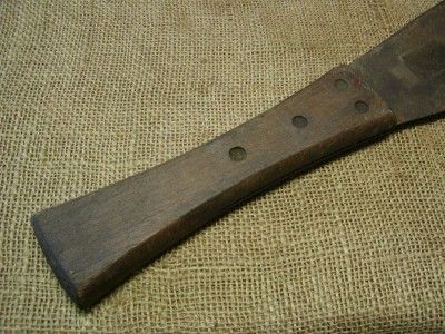 Vintage corn knife. The blade is riveted to the wooden handle. It 